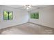 Bright bedroom with neutral carpet and light walls and featuring two windows that illuminate the space with natural light at 1419 Jules Ct, Charlotte, NC 28226