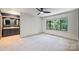 Primary bedroom boasts a large window with wooded view and ensuite bath with double vanity at 1419 Jules Ct, Charlotte, NC 28226