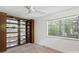 Bedroom with an open built-in bookcase, natural light, neutral carpet, and a large window overlooking nature at 1419 Jules Ct, Charlotte, NC 28226