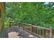 This beautiful wood deck features wood railings and provides a lovely view of the surrounding greenery at 1419 Jules Ct, Charlotte, NC 28226