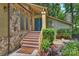 A welcoming entrance with a stone facade, steps leading to double doors, and manicured landscaping at 1419 Jules Ct, Charlotte, NC 28226