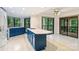 Bright kitchen featuring modern appliances, a gas cooktop island, blue cabinets, and glass sliding doors to outside at 1419 Jules Ct, Charlotte, NC 28226