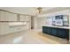 Spacious kitchen with an island cooktop, white cabinets, blue accents, and sliding doors to the deck at 1419 Jules Ct, Charlotte, NC 28226