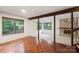 Inviting living room features parquet floors, stone fireplace and wooded view through expansive windows at 1419 Jules Ct, Charlotte, NC 28226