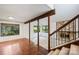 Open concept room features wooden beams, fireplace with stone surround, and hardwood flooring at 1419 Jules Ct, Charlotte, NC 28226