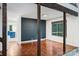 Well lit living room with hardwood floors, dark accent wall, and view of kitchen at 1419 Jules Ct, Charlotte, NC 28226