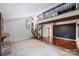 Open living room showcases staircase, dark accent wall, wood beams, and stone fireplace at 1419 Jules Ct, Charlotte, NC 28226