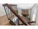 View of the living room fireplace with stone surround, carpeted steps, and hardwood flooring at 1419 Jules Ct, Charlotte, NC 28226
