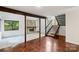 Open floor plan boasts beautiful hardwood floors, stone fireplace, and staircase leading to second floor at 1419 Jules Ct, Charlotte, NC 28226