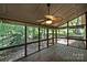 This screened porch features a ceiling fan and wood flooring providing a relaxing outdoor living space at 1419 Jules Ct, Charlotte, NC 28226