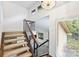 Bright staircase featuring carpeted steps, wood and metal railings, and a view to the main floor below at 1419 Jules Ct, Charlotte, NC 28226