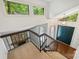 A carpeted staircase overlooks a modern entryway with a stone fireplace and double doors at 1419 Jules Ct, Charlotte, NC 28226