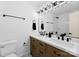 Modern bathroom featuring double sinks with vintage-style cabinets and matte black hardware at 1426 Larkfield Ln, Charlotte, NC 28210