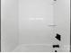 Clean, tiled tub and shower combination featuring white subway tiles and dark fixtures at 1426 Larkfield Ln, Charlotte, NC 28210