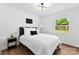 Bright bedroom with a modern light fixture, neutral decor, and view of the outdoors at 1426 Larkfield Ln, Charlotte, NC 28210