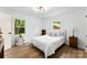 A well-lit bedroom featuring neutral colors, wood floors and a charming suitcase accent at 1426 Larkfield Ln, Charlotte, NC 28210
