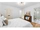 Bright bedroom with wood floors, white walls, modern lighting and a view to the bathroom at 1426 Larkfield Ln, Charlotte, NC 28210