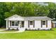 Charming single-story home featuring a well-maintained lawn and beautifully painted white brick at 1426 Larkfield Ln, Charlotte, NC 28210