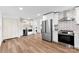 Modern kitchen featuring stainless steel appliances, hardwood floors, white cabinetry and countertop at 1426 Larkfield Ln, Charlotte, NC 28210
