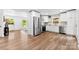 Open kitchen area featuring stainless steel appliances, white cabinets, and hardwood floors at 1426 Larkfield Ln, Charlotte, NC 28210