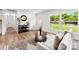 Inviting living room featuring hardwood floors, modern decor, and views of the landscaped neighborhood at 1426 Larkfield Ln, Charlotte, NC 28210