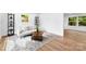 Bright living room with hardwood floors, a cozy rug, and an abundance of natural light at 1426 Larkfield Ln, Charlotte, NC 28210
