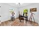 Bright office featuring hardwood floors, a modern light fixture, and a decorative globe at 1426 Larkfield Ln, Charlotte, NC 28210