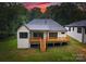 Back exterior featuring a wooden deck with stairs leading to the well-manicured lawn at 1622 Burtonwood Cir, Charlotte, NC 28212