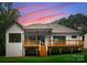 Home featuring a wooden deck, perfect for outdoor gatherings, with a well-maintained lawn at 1622 Burtonwood Cir, Charlotte, NC 28212