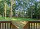 Scenic backyard view from the deck stairs, surrounded by lush greenery at 1622 Burtonwood Cir, Charlotte, NC 28212