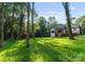 Serene backyard with a modern home overlooking a spacious, grassy lawn at 1622 Burtonwood Cir, Charlotte, NC 28212