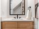 Modern bathroom featuring a stylish vanity with light wood cabinetry and a white countertop at 1622 Burtonwood Cir, Charlotte, NC 28212