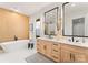 Bright bathroom featuring a soaking tub, double vanity with light wood cabinets, and modern fixtures at 1622 Burtonwood Cir, Charlotte, NC 28212