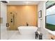 Spa-like bathroom with a freestanding tub, wood accent wall, a walk-in shower, and modern fixtures at 1622 Burtonwood Cir, Charlotte, NC 28212