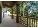 Inviting covered deck with wooden columns overlooking a landscaped yard at 1622 Burtonwood Cir, Charlotte, NC 28212