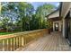 Relaxing view from a wooden deck with a wooded backdrop and view of backyard at 1622 Burtonwood Cir, Charlotte, NC 28212