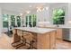 Bright kitchen with an island and barstools, stainless steel appliances, and views of the dining area at 1622 Burtonwood Cir, Charlotte, NC 28212