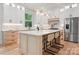 Spacious kitchen featuring an island with bar seating, stainless steel appliances, and modern lighting at 1622 Burtonwood Cir, Charlotte, NC 28212