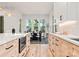 Kitchen with stainless appliances, light counters and cabinets, and a dining area in the background at 1622 Burtonwood Cir, Charlotte, NC 28212