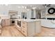 Open kitchen featuring a central island, stainless steel appliances, and an open view to the living area at 1622 Burtonwood Cir, Charlotte, NC 28212