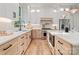 Beautiful kitchen with modern stainless steel appliances, light colored cabinets, light countertops, and wood floors at 1622 Burtonwood Cir, Charlotte, NC 28212
