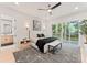 Modern bedroom with a king bed, ceiling fan, and sliding glass doors leading to a private deck at 1622 Burtonwood Cir, Charlotte, NC 28212