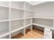 Well-organized pantry with white shelving and hardwood floors, perfect for storage at 1622 Burtonwood Cir, Charlotte, NC 28212
