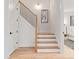 Bright staircase with hardwood floors and wooden handrail at 1622 Burtonwood Cir, Charlotte, NC 28212