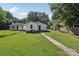 View of the home's backyard showing a garage and lush green grass at 1626 W Park Ave, Albemarle, NC 28001