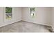This bedroom features neutral walls, carpet and two windows at 1626 W Park Ave, Albemarle, NC 28001