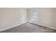 Comfortable bedroom with neutral walls, gray carpet, and a window offering natural light at 1626 W Park Ave, Albemarle, NC 28001