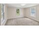 Bright and airy bedroom featuring soft carpeting, neutral walls, and two windows for ample natural light at 1626 W Park Ave, Albemarle, NC 28001