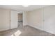 Cozy bedroom featuring neutral walls, gray carpet, and two closets at 1626 W Park Ave, Albemarle, NC 28001