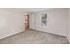 This bedroom features neutral walls, carpet and a doorway to the kitchen at 1626 W Park Ave, Albemarle, NC 28001